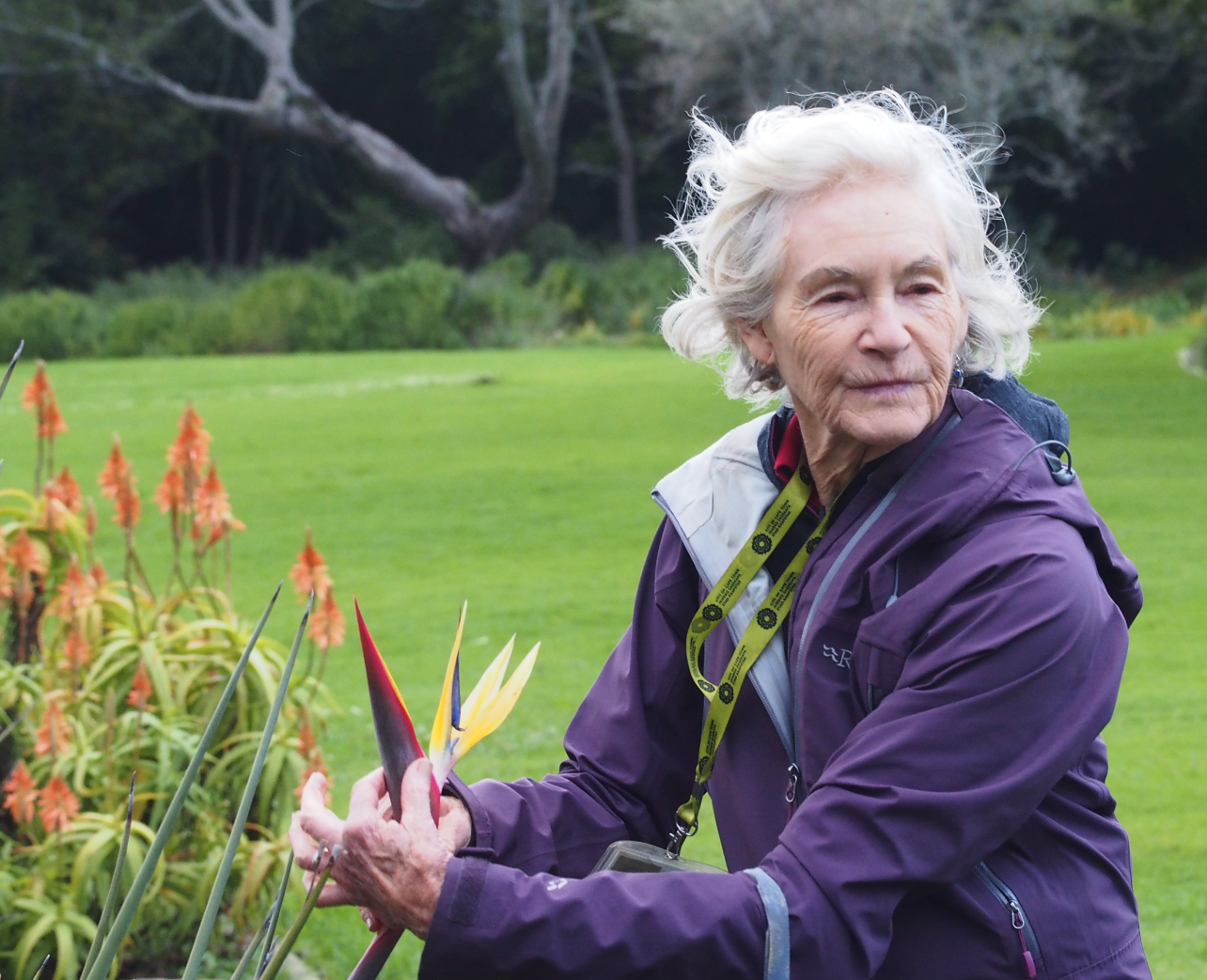 A woman holding onto a live flower